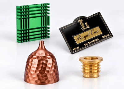 Custom metal parts including a heat sink, decorative plaque, metal shade and brass insert